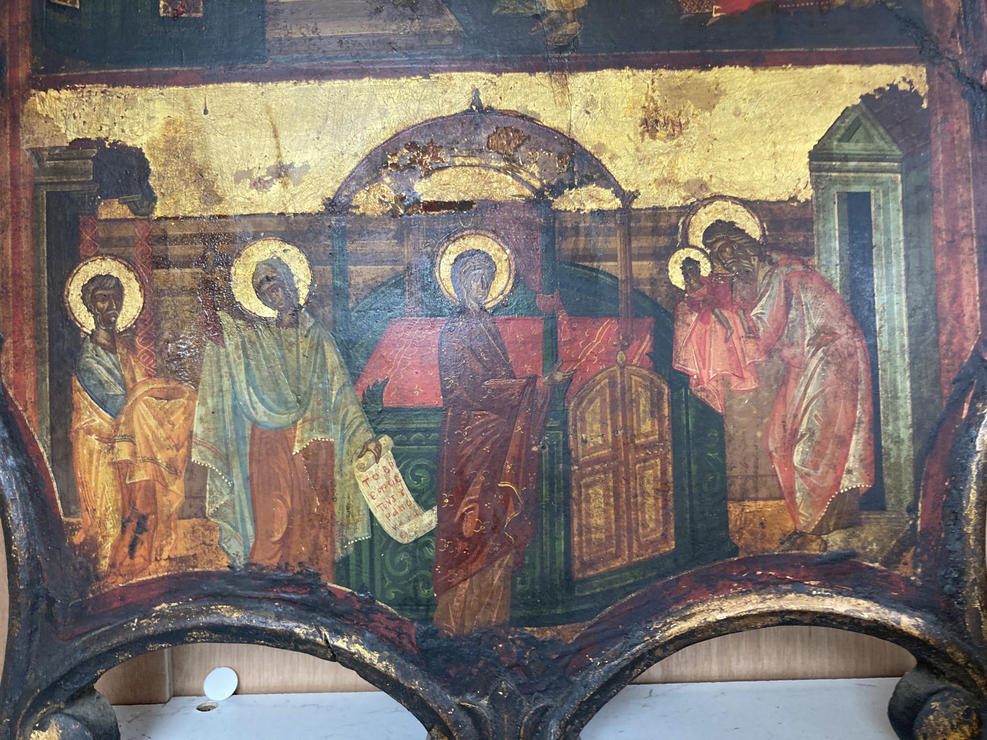 A tempera on panel icon with two scenes from the bible, shaped, overall 54 x 36.5cm